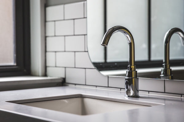 Hands under the clear water from a faucet—a daily part of the face-washing routine